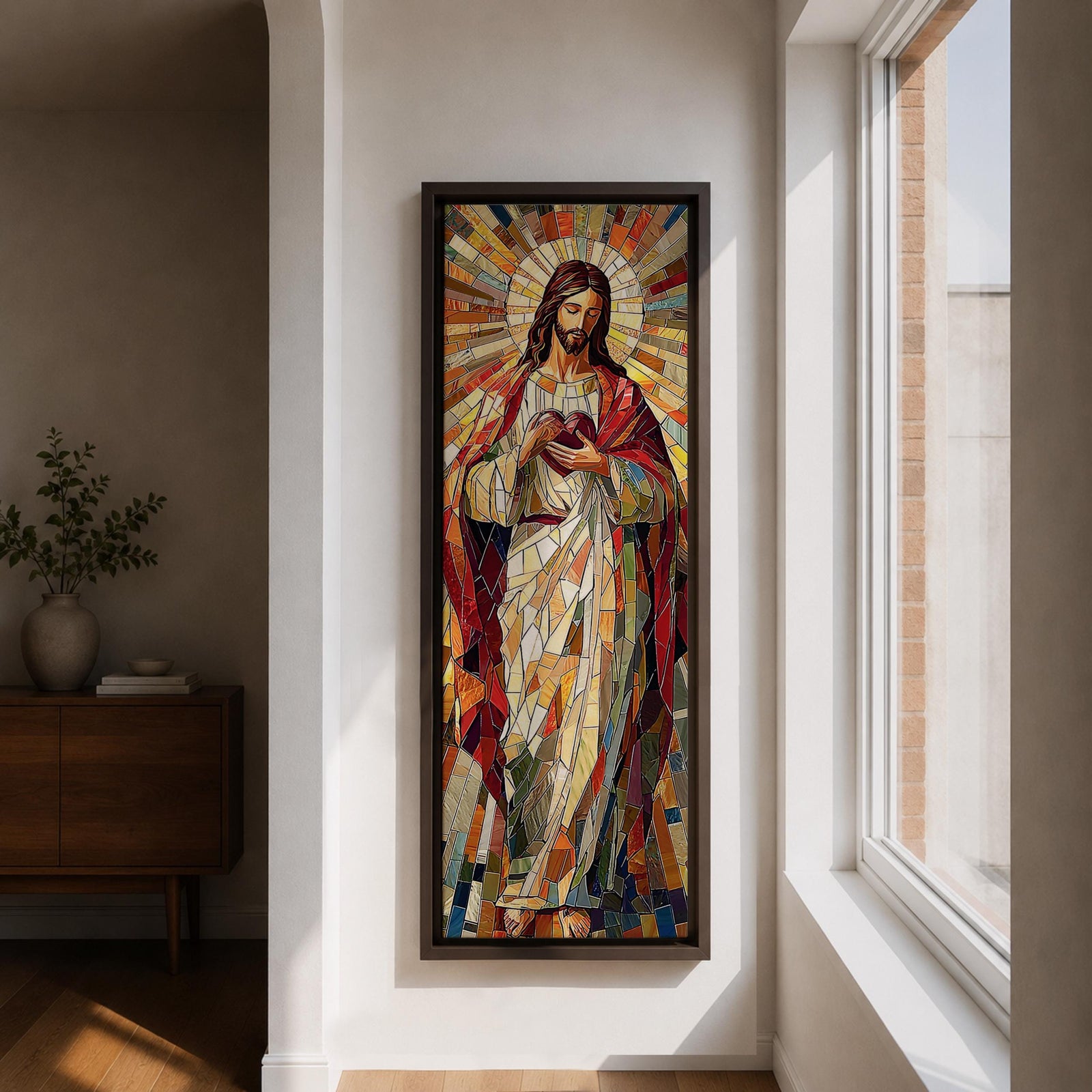 Long vertical stained glass style painting of Jesus Christ holding the Sacred Heart at his chest while radiant golden rays form a halo behind him. The figure is composed of colorful mosaic glass segments in red gold blue and white creating a luminous Christian devotional composition.