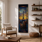Long vertical painting of the Eiffel Tower seen through an open window with balcony railings and flowers in the foreground. A dramatic sunset sky glows with orange and blue tones above the Paris skyline while expressive brushstrokes create a romantic cityscape composition.