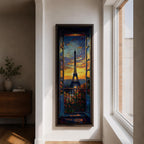 Long vertical painting of the Eiffel Tower seen through an open window with balcony railings and flowers in the foreground. A dramatic sunset sky glows with orange and blue tones above the Paris skyline while expressive brushstrokes create a romantic cityscape composition.