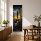 Long vertical painting of the Eiffel Tower seen through an open window with balcony railings and flowers in the foreground. A dramatic sunset sky glows with orange and blue tones above the Paris skyline while expressive brushstrokes create a romantic cityscape composition.