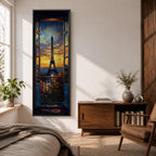 Long vertical painting of the Eiffel Tower seen through an open window with balcony railings and flowers in the foreground. A dramatic sunset sky glows with orange and blue tones above the Paris skyline while expressive brushstrokes create a romantic cityscape composition.