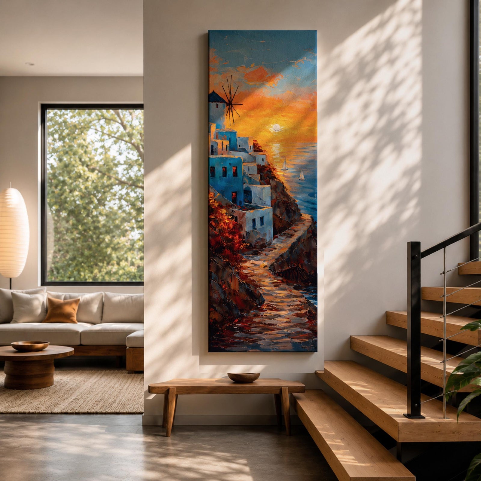 A tall vertical painting depicts a Santorini coastal scene with whitewashed buildings perched along a cliffside, a winding stone path leading toward the sea, and a glowing sunset casting warm orange and gold light across the sky and water, with a windmill silhouette and small sailboats adding depth to the vibrant Mediterranean composition.