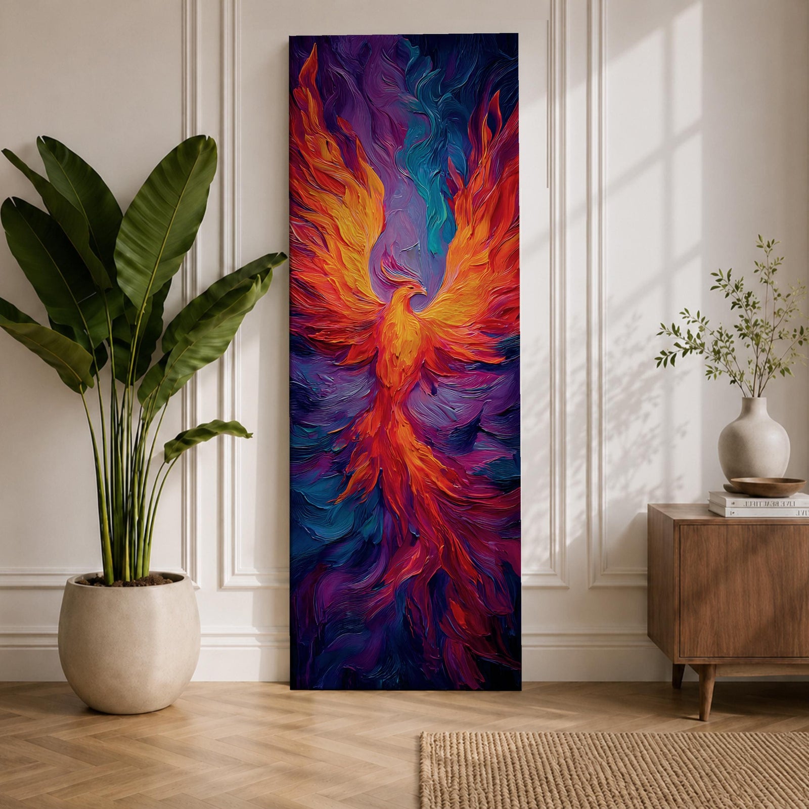 A tall vertical painting depicts a vibrant phoenix with wings fully extended, rendered in bold flowing strokes of fiery orange, red, and gold blending into deep purples and blues, its elongated tail cascading downward in fluid motion, creating a dynamic abstract firebird rising with intense color contrast and expressive texture.