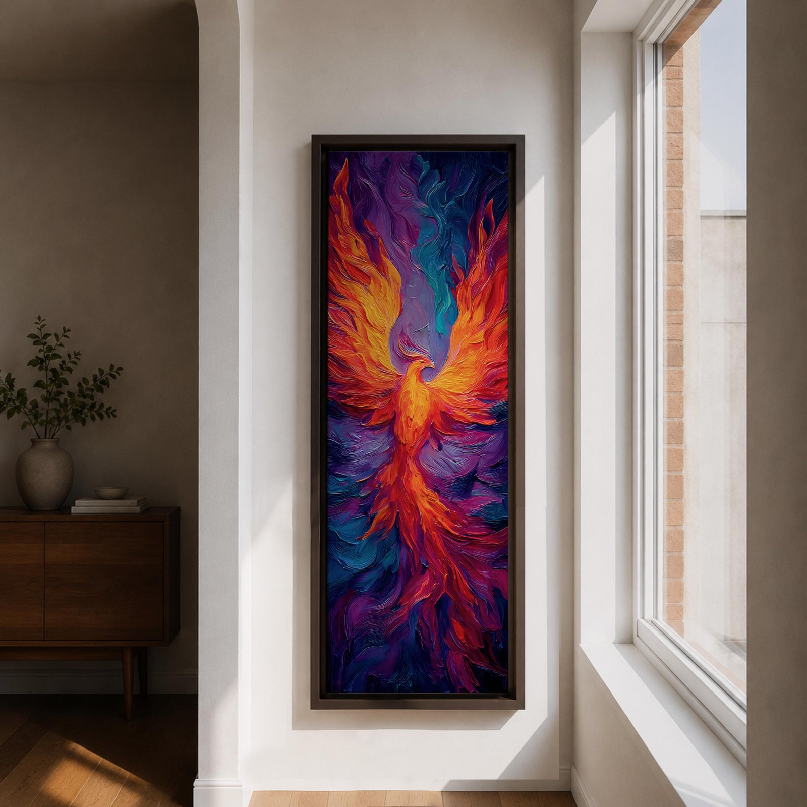 A tall vertical painting depicts a vibrant phoenix with wings fully extended, rendered in bold flowing strokes of fiery orange, red, and gold blending into deep purples and blues, its elongated tail cascading downward in fluid motion, creating a dynamic abstract firebird rising with intense color contrast and expressive texture.