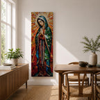 Long vertical stained glass style depiction of Our Lady of Guadalupe with hands clasped in prayer. She wears a green mantle decorated with stars and a red robe while radiant golden rays form a halo behind her, composed of colorful mosaic glass pieces forming a luminous devotional image.