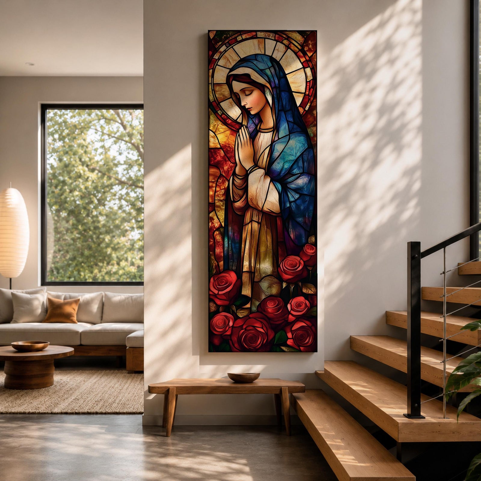 Long vertical stained glass style depiction of the Virgin Mary with hands clasped in prayer. She wears a blue mantle and cream robe while a circular halo glows behind her head and red roses bloom at her feet, all formed with colorful glass segments in a luminous devotional composition.