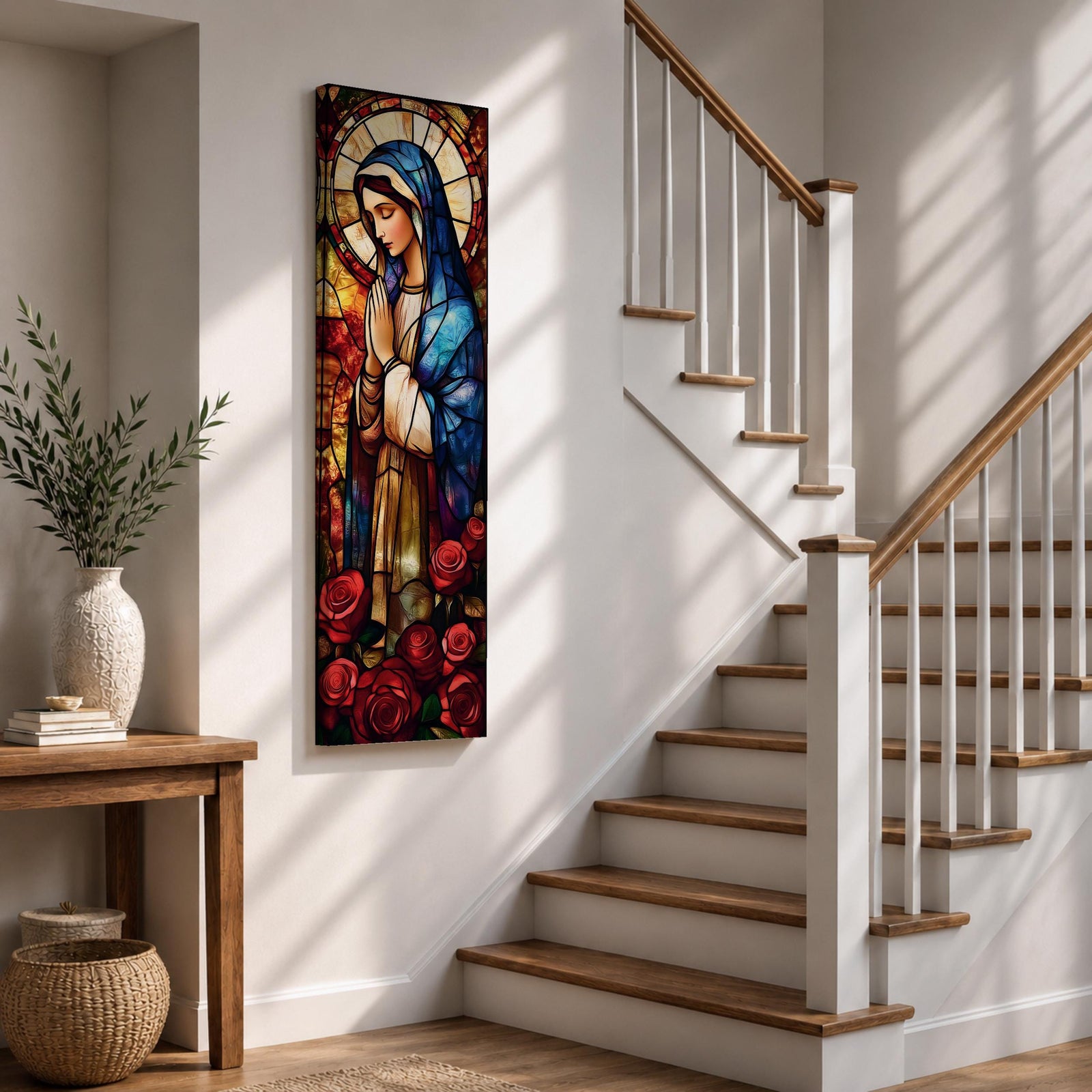Long vertical stained glass style depiction of the Virgin Mary with hands clasped in prayer. She wears a blue mantle and cream robe while a circular halo glows behind her head and red roses bloom at her feet, all formed with colorful glass segments in a luminous devotional composition.