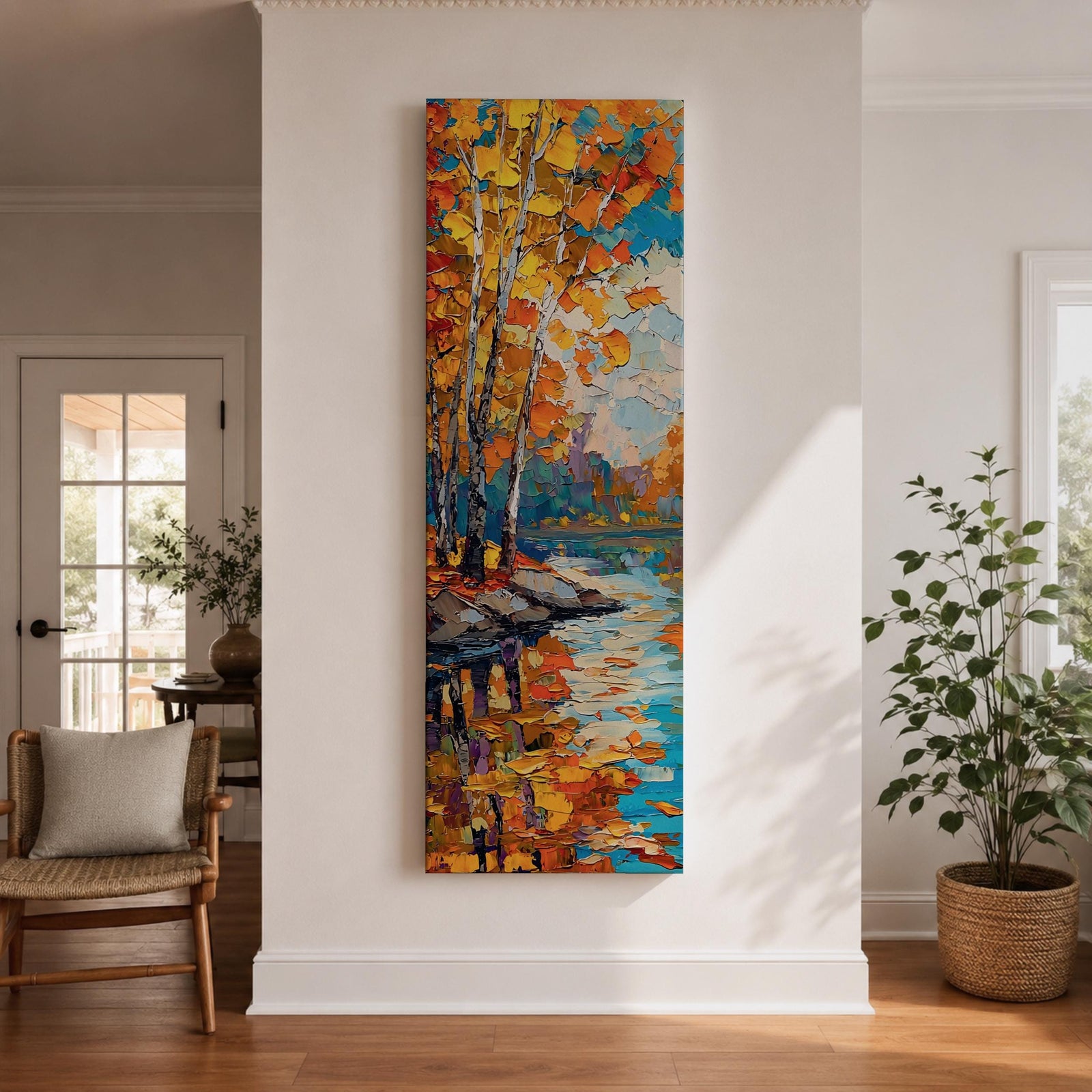 Tall vertical landscape painting of slender birch trees with golden autumn leaves along a calm reflective river. Thick palette knife oil brushstrokes create vibrant fall colors of orange, yellow, and blue with the trees mirrored in the water while distant forest and sky appear softly textured in the background.