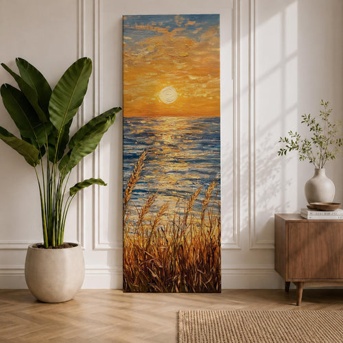 Tall vertical seascape painting showing a glowing sunset above the ocean horizon with golden sunlight reflecting across textured blue water. Coastal dune grasses rise in the foreground while warm orange clouds spread across the sky, painted with thick expressive oil brushstrokes capturing light across the sea.