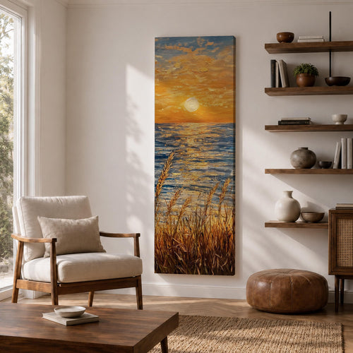 Tall vertical seascape painting showing a glowing sunset above the ocean horizon with golden sunlight reflecting across textured blue water. Coastal dune grasses rise in the foreground while warm orange clouds spread across the sky, painted with thick expressive oil brushstrokes capturing light across the sea.