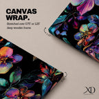 Tall vertical botanical artwork featuring glowing neon flowers in vibrant rainbow colors against a deep black background. Large luminous blossoms in pink, orange, purple, and blue are surrounded by detailed leaves, creating a modern floral composition with bold contrast and iridescent color transitions.