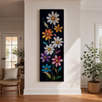 Tall vertical floral artwork featuring colorful daisy flowers in white, orange, purple, pink, and blue rising along slender green stems against a deep black background. The composition highlights bright petals and yellow centers with smooth painterly details and vibrant botanical contrast.