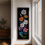 Tall vertical floral artwork featuring colorful daisy flowers in white, orange, purple, pink, and blue rising along slender green stems against a deep black background. The composition highlights bright petals and yellow centers with smooth painterly details and vibrant botanical contrast.