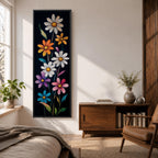 Tall vertical floral artwork featuring colorful daisy flowers in white, orange, purple, pink, and blue rising along slender green stems against a deep black background. The composition highlights bright petals and yellow centers with smooth painterly details and vibrant botanical contrast.