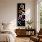 Tall vertical floral artwork featuring colorful daisy flowers in white, orange, purple, pink, and blue rising along slender green stems against a deep black background. The composition highlights bright petals and yellow centers with smooth painterly details and vibrant botanical contrast.