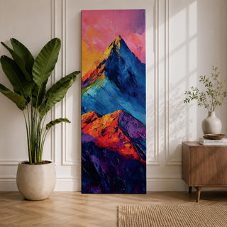 Tall vertical abstract mountain painting with bold colorful peaks in vibrant blue, red, purple, and yellow tones. Thick impasto brushstrokes create dramatic alpine ridges beneath a bright pink and orange sky, forming a modern expressive mountain landscape.