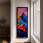 Tall vertical abstract mountain painting with bold colorful peaks in vibrant blue, red, purple, and yellow tones. Thick impasto brushstrokes create dramatic alpine ridges beneath a bright pink and orange sky, forming a modern expressive mountain landscape.