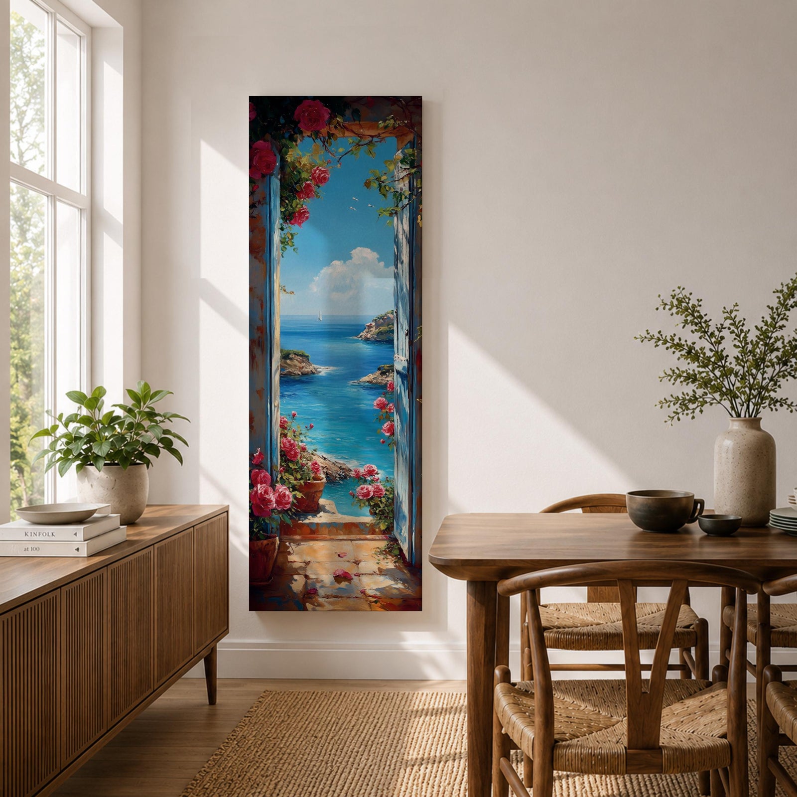 Tall vertical coastal painting showing an Italian ocean view framed by an open doorway with pink flowers and potted plants. The bright Mediterranean sea stretches toward rocky cliffs and a distant sailboat beneath a clear blue sky.