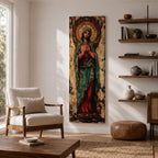 Long vertical painting of the Virgin Mary standing with hands clasped in prayer, wearing a deep red robe and teal mantle. An ornate circular golden halo with sacred symbols forms a radiant backdrop while textured brushwork and aged tones create a traditional Catholic devotional icon style composition.