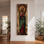 Long vertical painting of the Virgin Mary standing with hands clasped in prayer, wearing a deep red robe and teal mantle. An ornate circular golden halo with sacred symbols forms a radiant backdrop while textured brushwork and aged tones create a traditional Catholic devotional icon style composition.