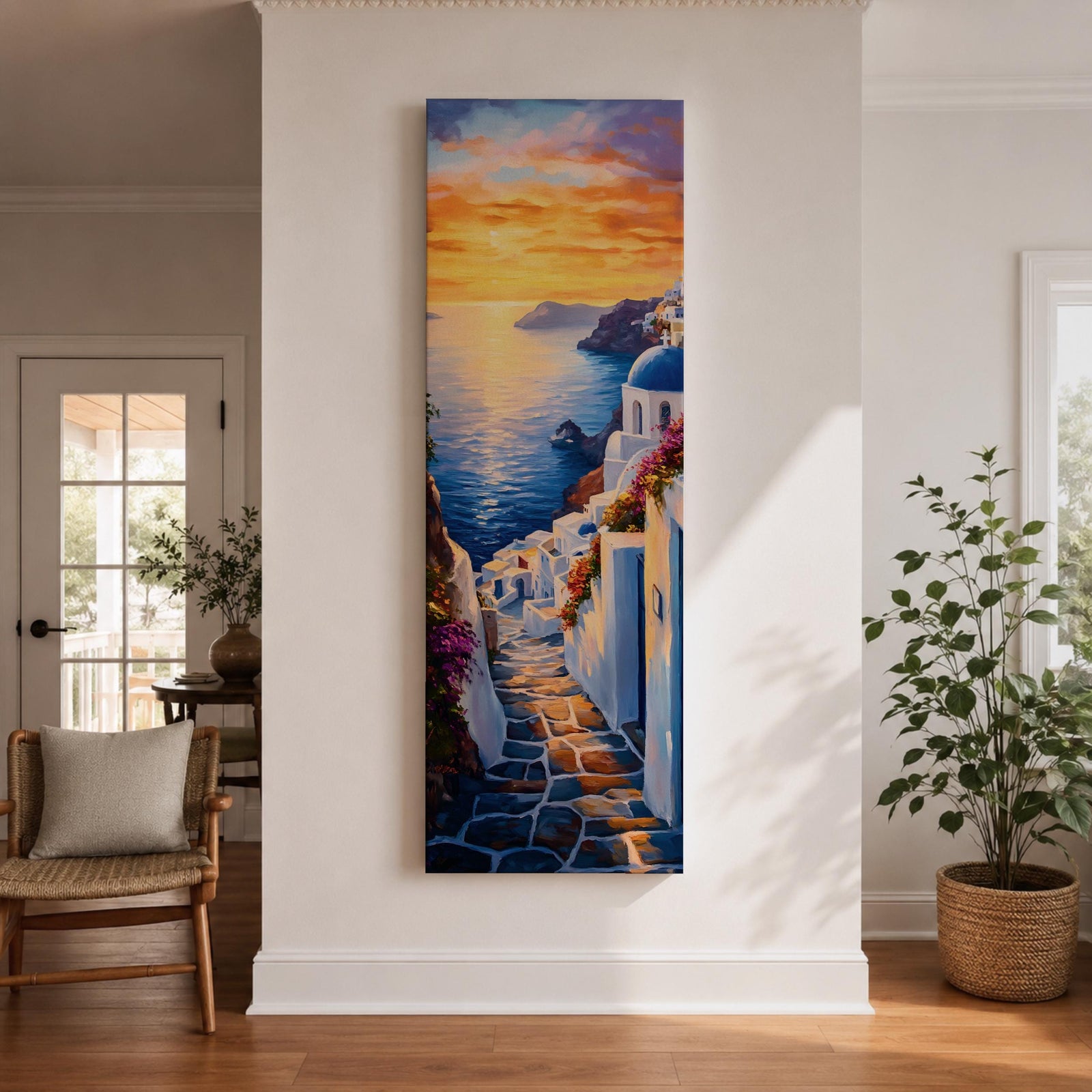 Long vertical painting of a Santorini coastal village with whitewashed buildings and a blue dome church overlooking the sea at sunset. A stone pathway descends between bright white walls toward the shoreline while golden sunlight reflects across calm water and warm clouds fill the sky.