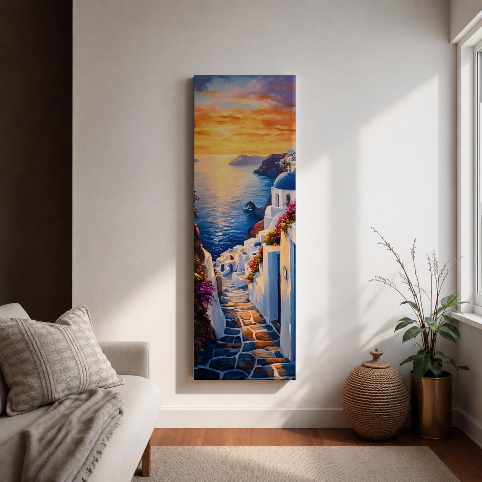 Long vertical painting of a Santorini coastal village with whitewashed buildings and a blue dome church overlooking the sea at sunset. A stone pathway descends between bright white walls toward the shoreline while golden sunlight reflects across calm water and warm clouds fill the sky.