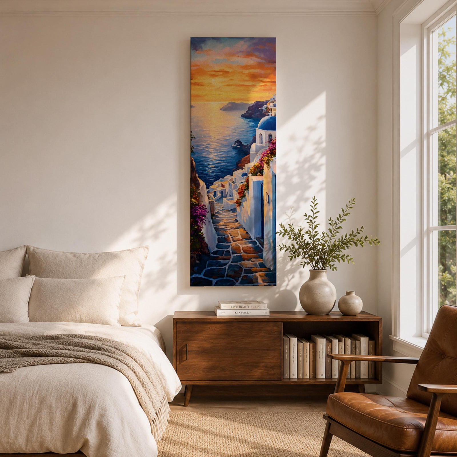 Long vertical painting of a Santorini coastal village with whitewashed buildings and a blue dome church overlooking the sea at sunset. A stone pathway descends between bright white walls toward the shoreline while golden sunlight reflects across calm water and warm clouds fill the sky.