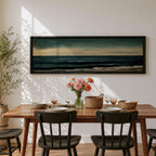 Panoramic seascape painting showing dark rolling waves beneath a dramatic cloudy sky with faint light breaking along the distant horizon. Deep teal and navy tones blend across the water while textured brushstrokes form soft foam along the shoreline, creating a moody minimalist coastal composition across the wide horizontal canvas.