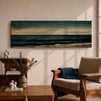 Panoramic seascape painting showing dark rolling waves beneath a dramatic cloudy sky with faint light breaking along the distant horizon. Deep teal and navy tones blend across the water while textured brushstrokes form soft foam along the shoreline, creating a moody minimalist coastal composition across the wide horizontal canvas.