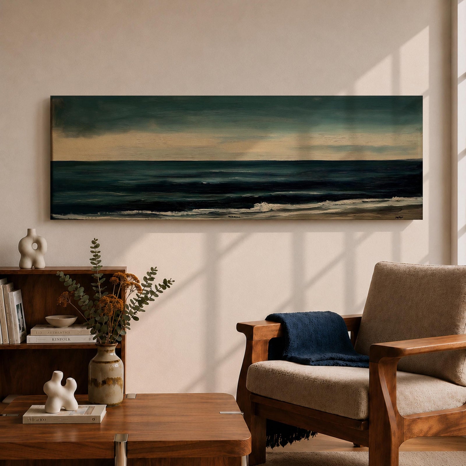 Panoramic seascape painting showing dark rolling waves beneath a dramatic cloudy sky with faint light breaking along the distant horizon. Deep teal and navy tones blend across the water while textured brushstrokes form soft foam along the shoreline, creating a moody minimalist coastal composition across the wide horizontal canvas.