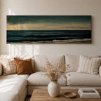 Panoramic seascape painting showing dark rolling waves beneath a dramatic cloudy sky with faint light breaking along the distant horizon. Deep teal and navy tones blend across the water while textured brushstrokes form soft foam along the shoreline, creating a moody minimalist coastal composition across the wide horizontal canvas.