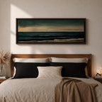 Panoramic seascape painting showing dark rolling waves beneath a dramatic cloudy sky with faint light breaking along the distant horizon. Deep teal and navy tones blend across the water while textured brushstrokes form soft foam along the shoreline, creating a moody minimalist coastal composition across the wide horizontal canvas.