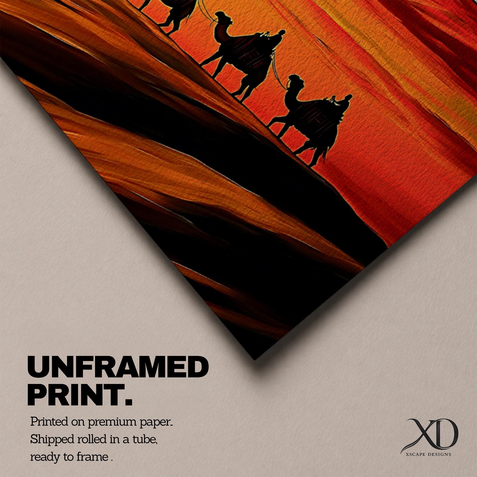 Panoramic desert sunset painting featuring a silhouette caravan of camels and riders walking along rolling sand dunes beneath a glowing red and orange sky. The low sun sits near the horizon while layered desert dunes stretch into the distance, creating a dramatic wide composition across the desert landscape.