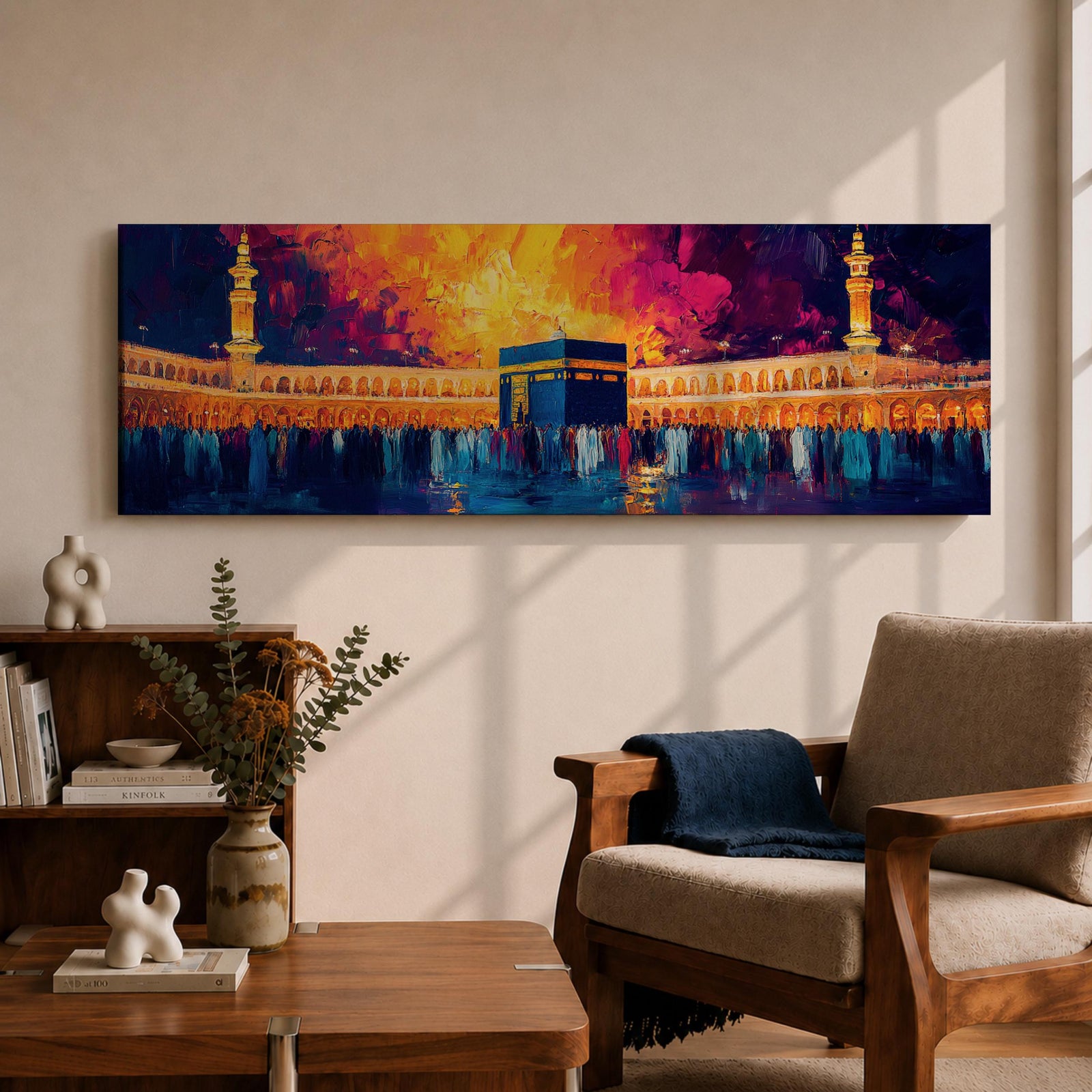 Panoramic painting of the Kaaba at Masjid Al Haram in Mecca surrounded by worshippers within the illuminated mosque courtyard. Tall minarets rise on either side while glowing sunset colors of gold, magenta, and deep blue fill the sky above the sacred Islamic landmark across the wide horizontal composition.