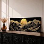 Panoramic moonlit mountain landscape painting featuring layered black mountains outlined with flowing gold lines beneath a glowing full moon. Soft golden clouds drift across a dark sky while ridges and valleys unfold across the wide composition, creating a dramatic celestial scene with textured metallic accents.