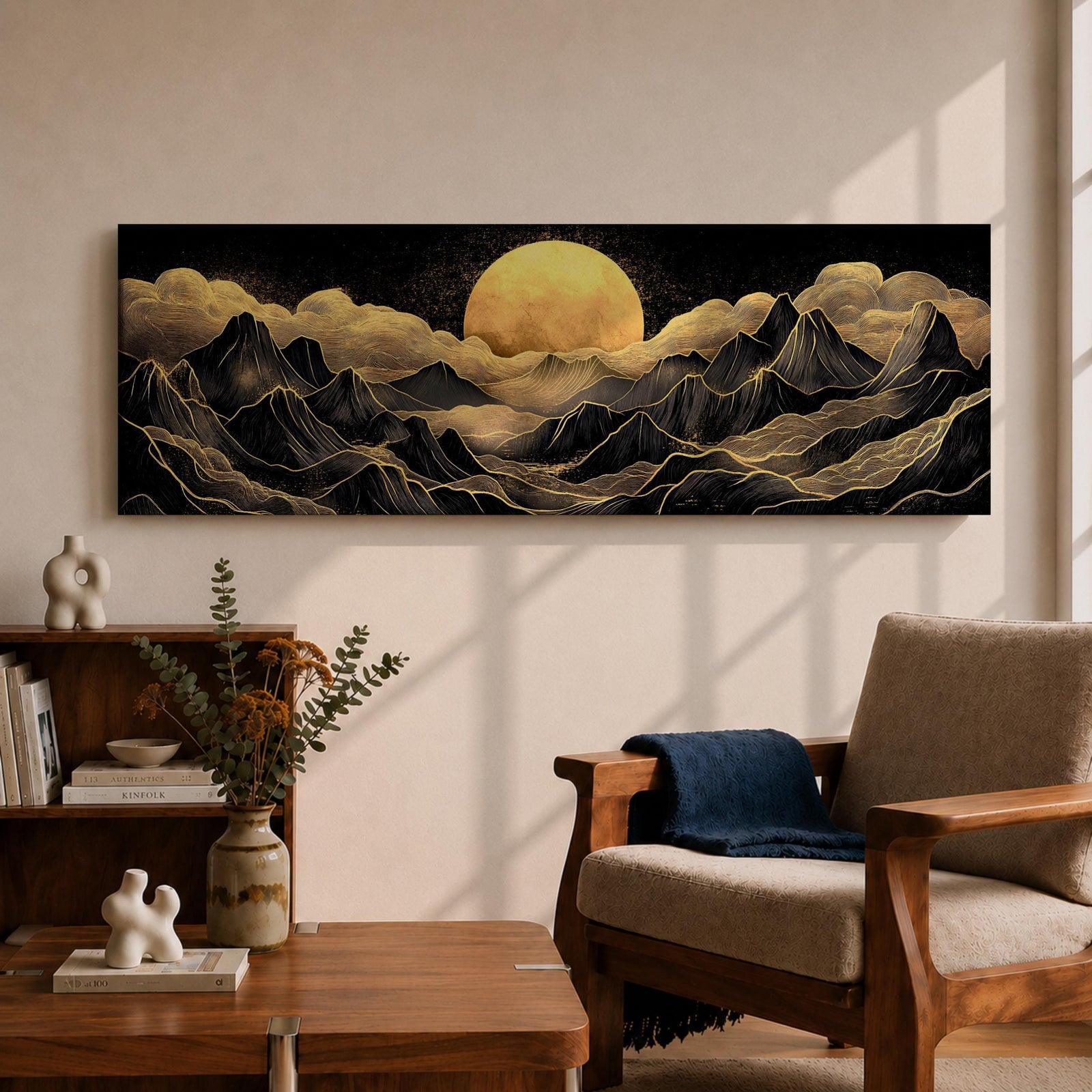 Panoramic moonlit mountain landscape painting featuring layered black mountains outlined with flowing gold lines beneath a glowing full moon. Soft golden clouds drift across a dark sky while ridges and valleys unfold across the wide composition, creating a dramatic celestial scene with textured metallic accents.