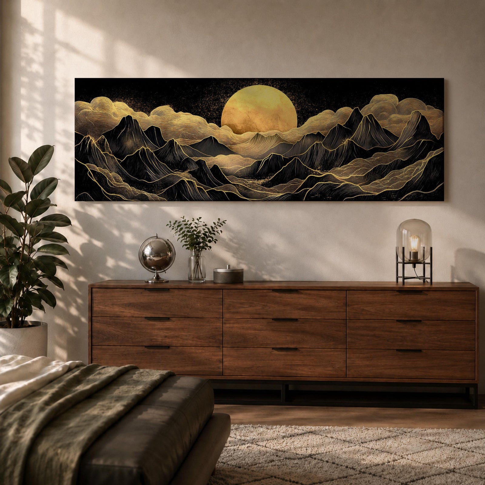 Panoramic moonlit mountain landscape painting featuring layered black mountains outlined with flowing gold lines beneath a glowing full moon. Soft golden clouds drift across a dark sky while ridges and valleys unfold across the wide composition, creating a dramatic celestial scene with textured metallic accents.