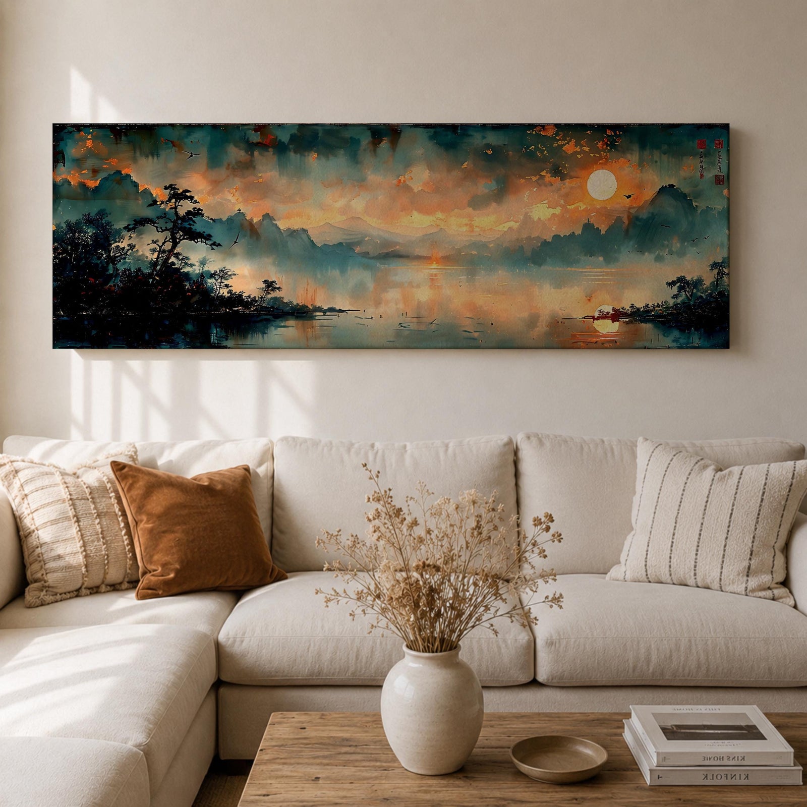 Panoramic Chinese landscape painting of misty mountains rising above a tranquil lake at sunset with warm orange light reflecting across the water. Dark tree silhouettes frame the shoreline while distant peaks fade into atmospheric haze beneath dramatic clouds in a traditional oriental scenery composition.