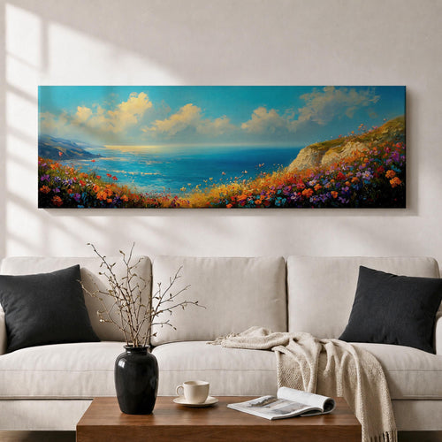 Panoramic coastal landscape painting of colorful wildflowers blooming along a seaside cliff overlooking a bright blue ocean. Vibrant pink, orange, purple, and yellow flowers fill the foreground while rolling waves and distant coastline stretch beneath a wide sky with soft clouds in a luminous horizontal composition.