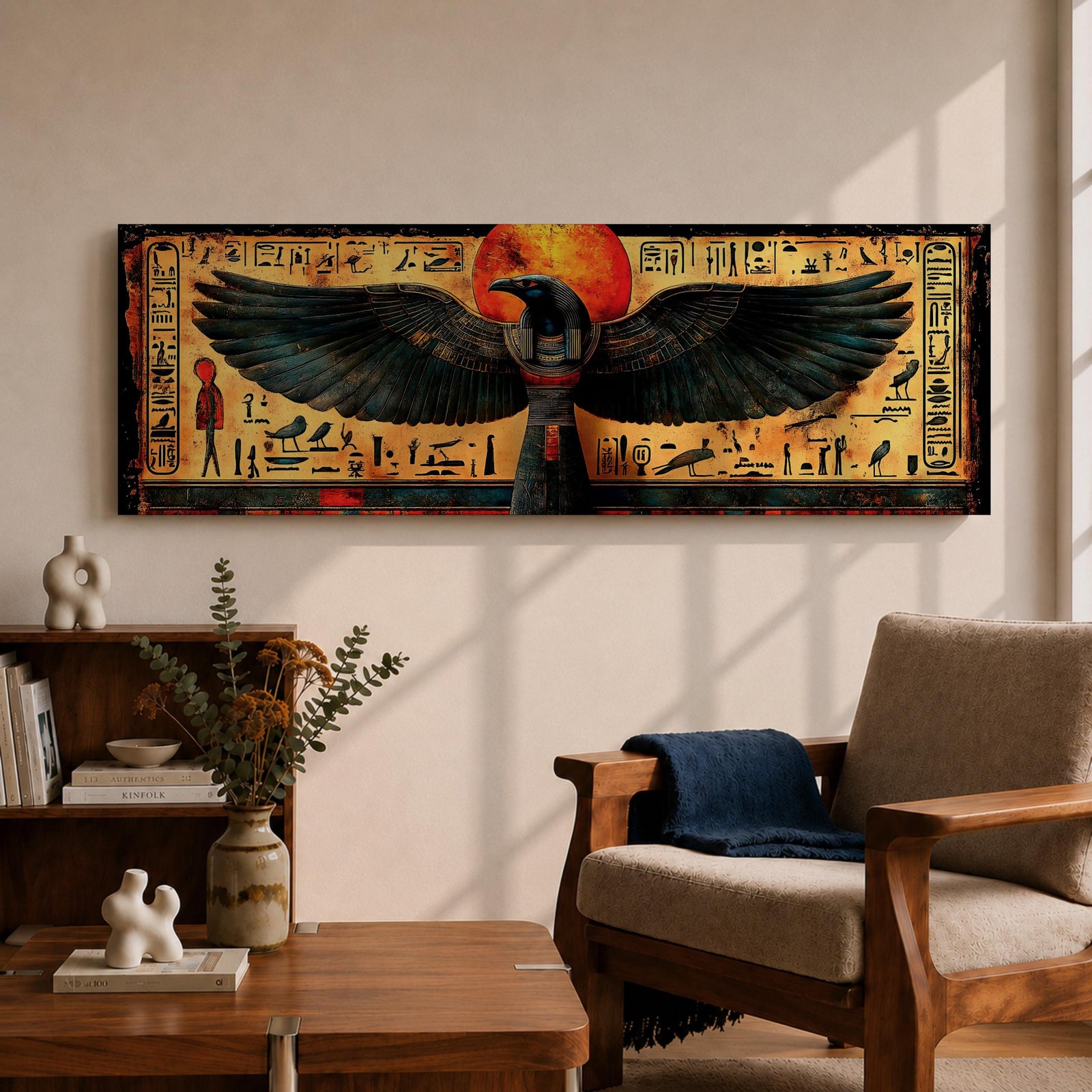 Panoramic ancient Egyptian style artwork featuring the falcon headed god Horus with wide outstretched wings beneath a glowing red sun disk. Hieroglyphic symbols and figures frame the composition while textured gold and dark tones highlight the wings and central deity across the wide symmetrical scene.