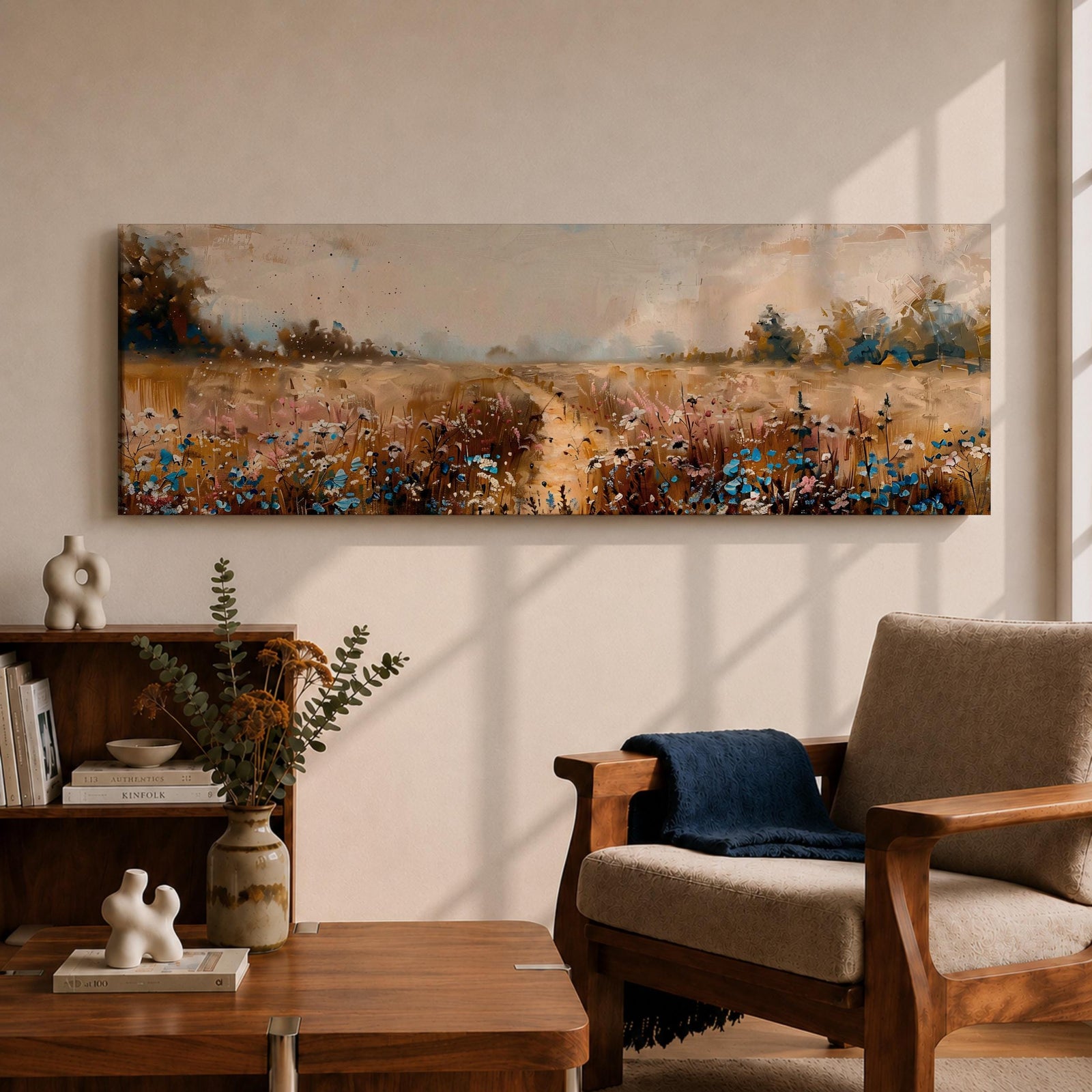 Panoramic wildflower meadow landscape painting featuring a soft rural field filled with scattered blue and white flowers across golden grasses. A narrow path leads through the meadow toward distant trees and open countryside beneath a muted cloudy sky, with textured brushstrokes creating depth across the wide pastoral scene.