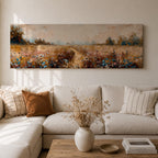 Panoramic wildflower meadow landscape painting featuring a soft rural field filled with scattered blue and white flowers across golden grasses. A narrow path leads through the meadow toward distant trees and open countryside beneath a muted cloudy sky, with textured brushstrokes creating depth across the wide pastoral scene.