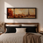 A long panoramic watercolor style painting of the Eiffel Tower rising above the Paris skyline beside the Seine River. Warm autumn foliage frames the scene while a bridge crosses the river and historic buildings sit beneath a glowing sky, creating a romantic Paris cityscape in a wide horizontal composition.