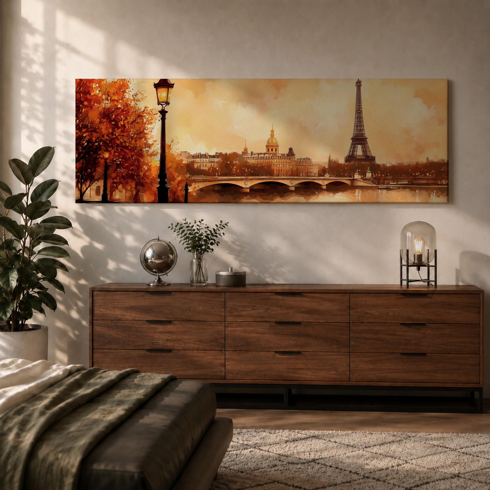A long panoramic watercolor style painting of the Eiffel Tower rising above the Paris skyline beside the Seine River. Warm autumn foliage frames the scene while a bridge crosses the river and historic buildings sit beneath a glowing sky, creating a romantic Paris cityscape in a wide horizontal composition.