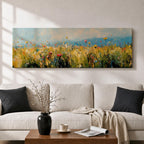 Panoramic wildflower meadow painting featuring tall golden grasses mixed with scattered red, yellow, and blue flowers swaying across an open field. Loose textured brushstrokes create depth through the meadow while a soft blue sky and distant horizon stretch across the wide landscape composition.
