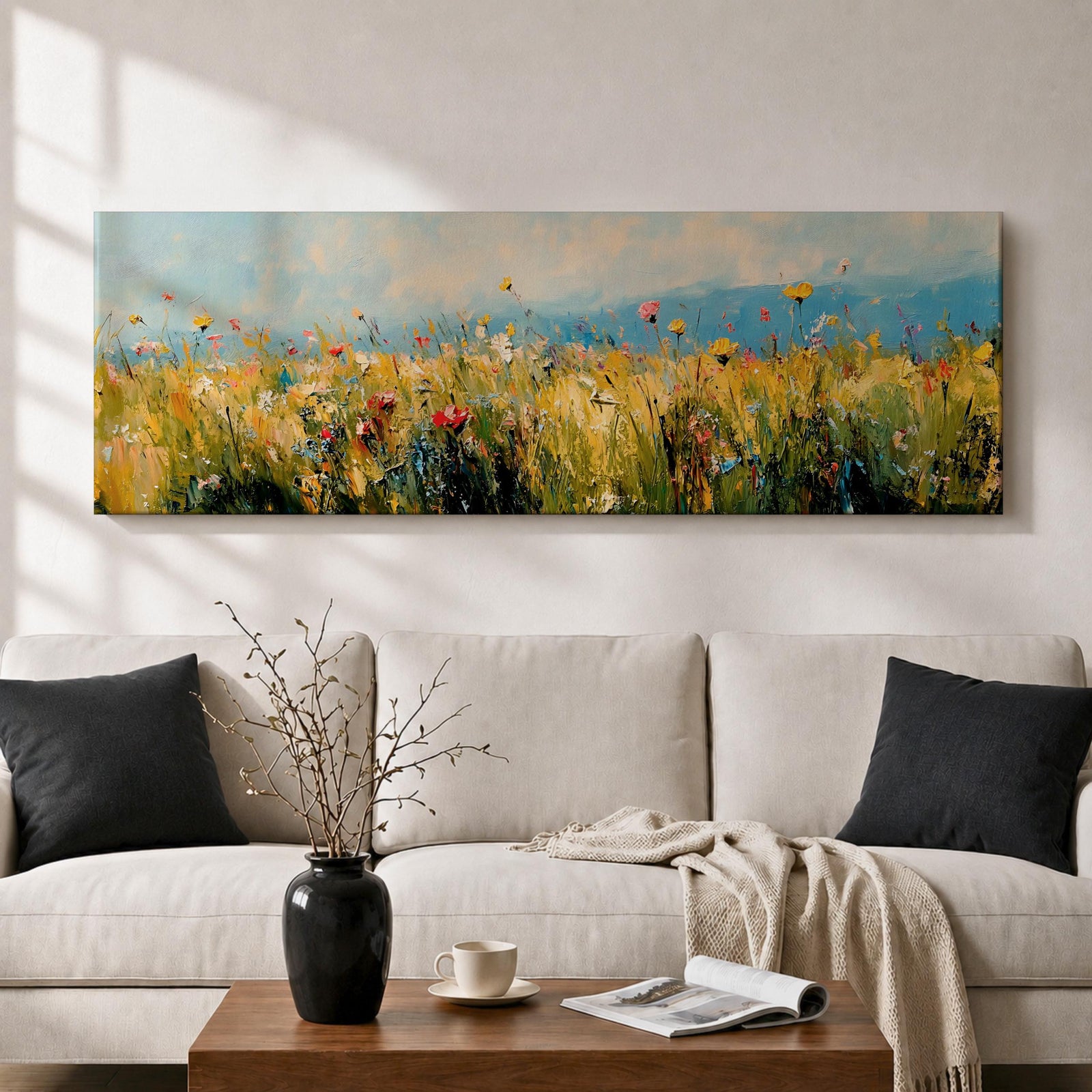 Panoramic wildflower meadow painting featuring tall golden grasses mixed with scattered red, yellow, and blue flowers swaying across an open field. Loose textured brushstrokes create depth through the meadow while a soft blue sky and distant horizon stretch across the wide landscape composition.