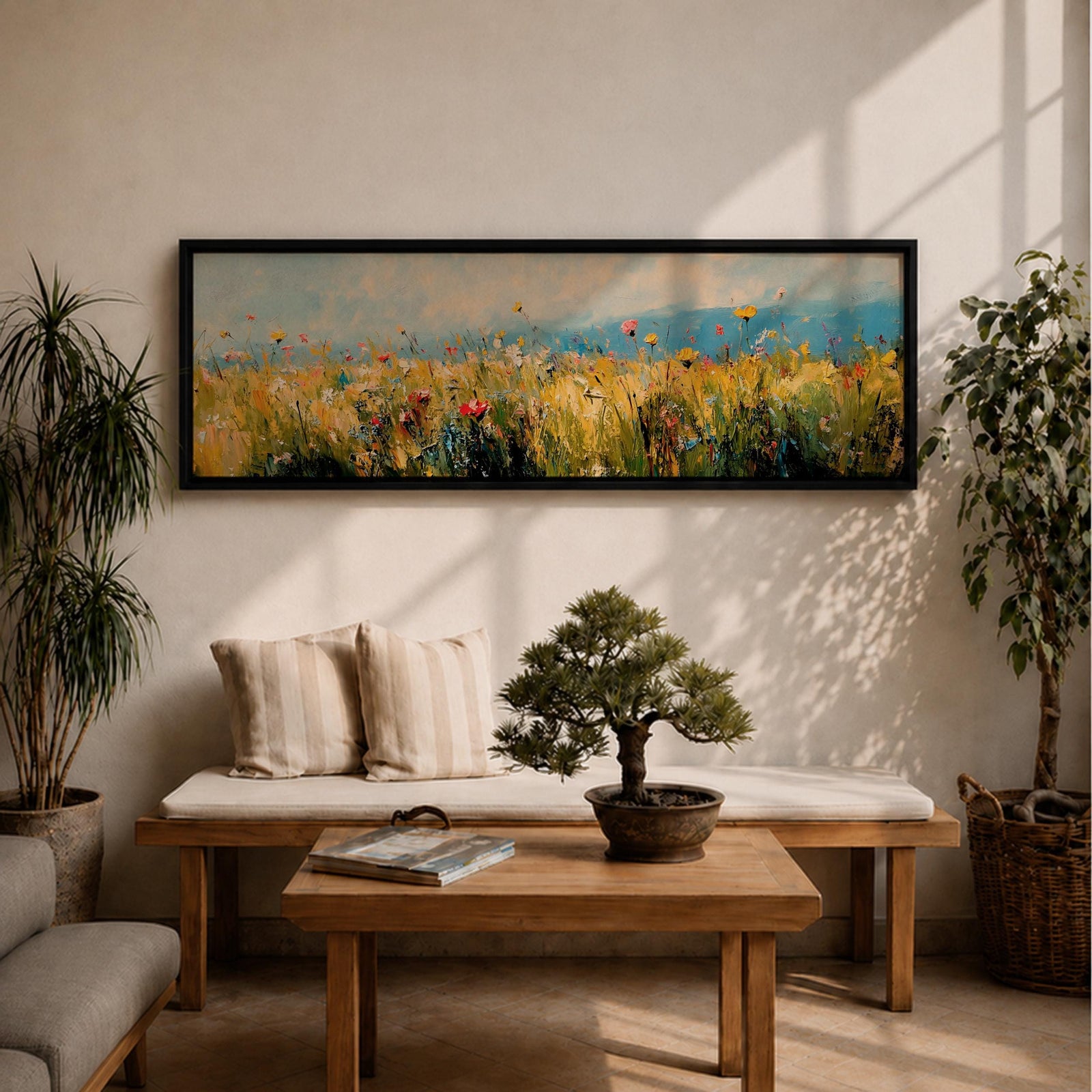 Panoramic wildflower meadow painting featuring tall golden grasses mixed with scattered red, yellow, and blue flowers swaying across an open field. Loose textured brushstrokes create depth through the meadow while a soft blue sky and distant horizon stretch across the wide landscape composition.