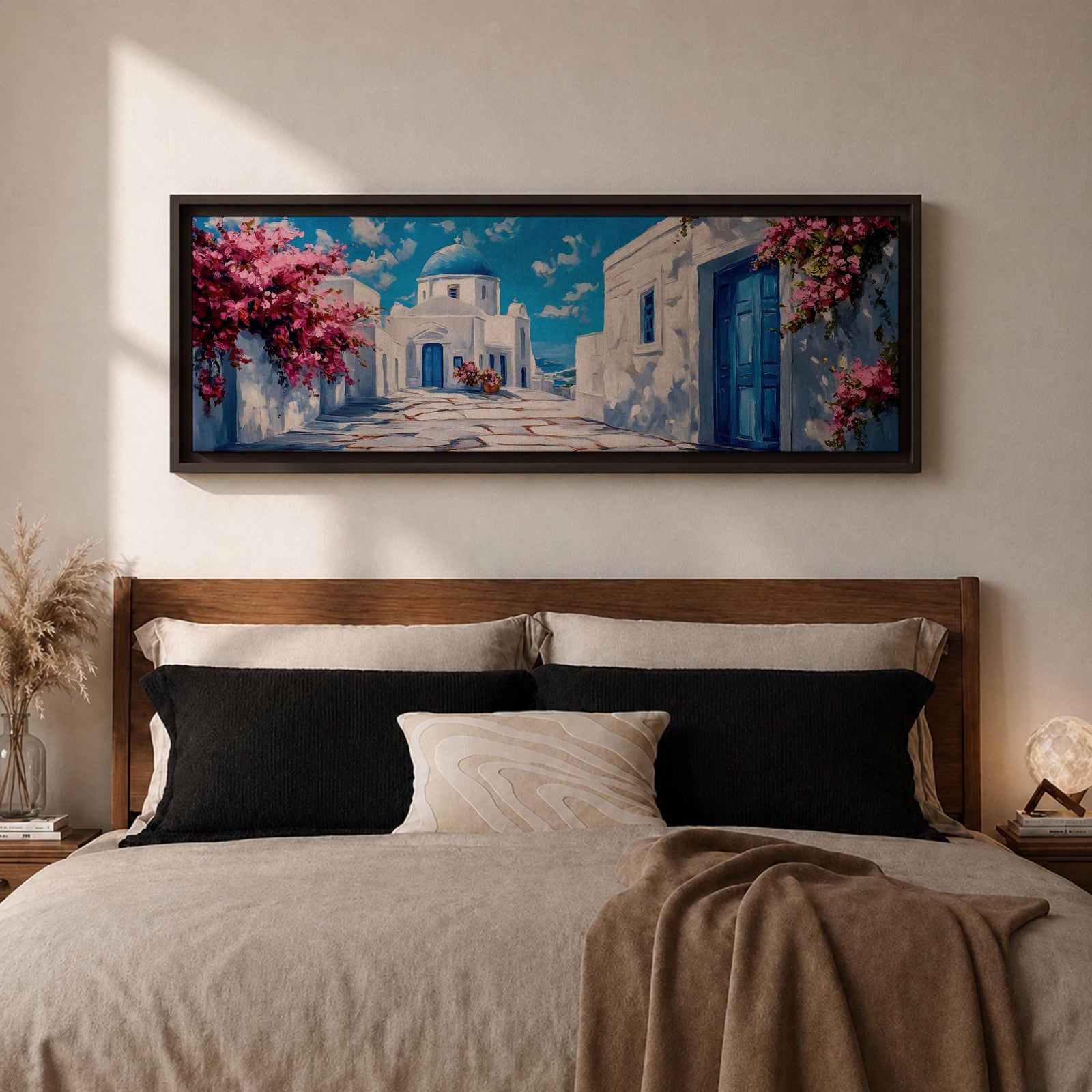 Panoramic painting of a Santorini village featuring whitewashed buildings with blue doors and a domed church along a sunlit stone pathway. Pink bougainvillea flowers frame the scene while bright blue sky and distant Aegean Sea appear beyond the island architecture across the wide composition.