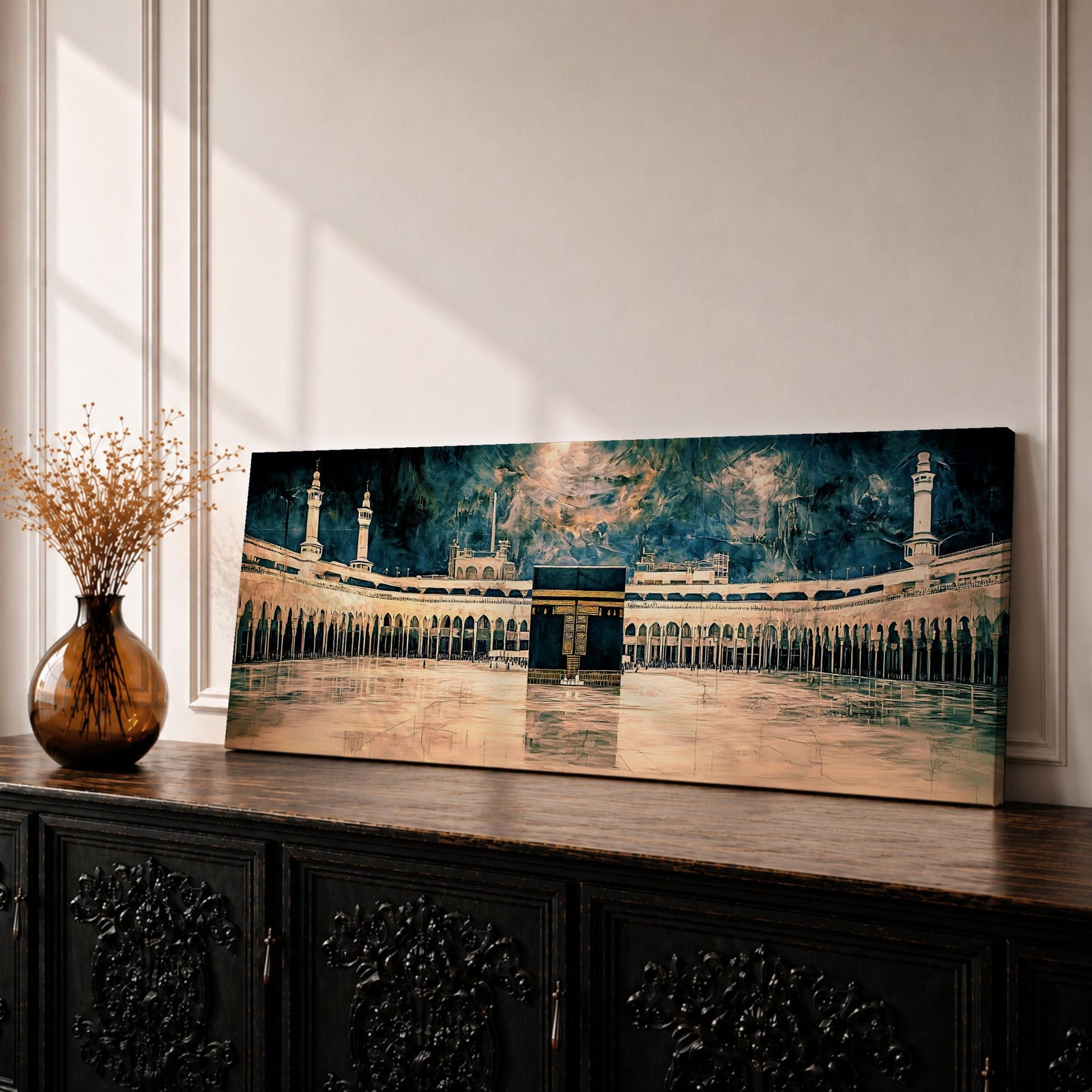 Panoramic painting of the Kaaba at Masjid Al Haram in Makkah surrounded by grand mosque arches and tall minarets. The sacred black cube stands centered within the wide courtyard reflecting on polished stone while dramatic clouds gather above the holy sanctuary skyline.