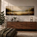 Panoramic meadow landscape painting showing soft golden grasses and delicate wildflowers across an open countryside field with distant trees and a glowing sky creating a peaceful prairie scene.